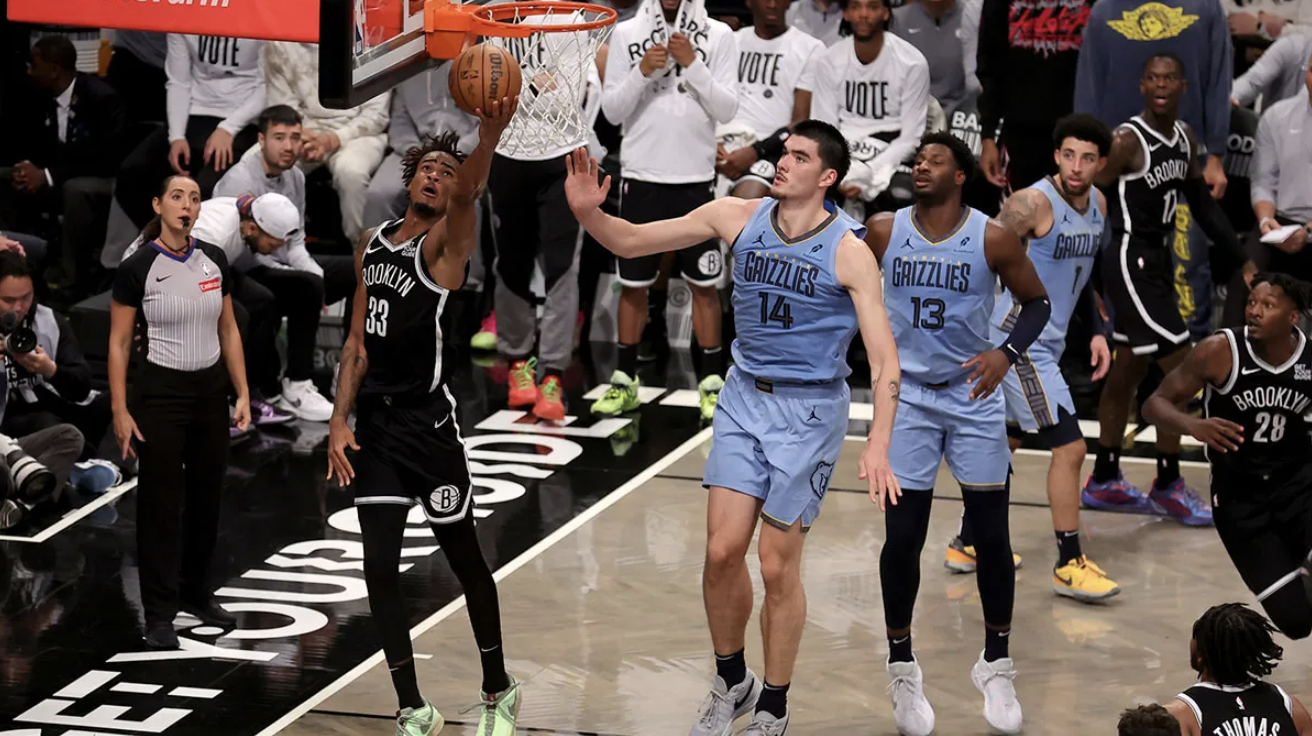 Brooklyn Nets center Nic Claxton (33) drives to the basket against Memphis Grizzlies center Zach Edey (14) and forward Jaren Jackson Jr. (13) and guard Scotty Pippen Jr. (1) during the fourth quarter at Barclays Center.